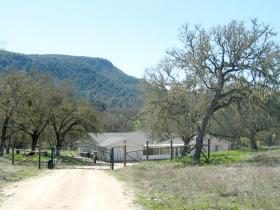 Entrance Into Deer-Fenced Area Around Home, Approximately 3 Acres.  There Is A Second Electric Gate Here.  See Tierra Redonda Mountain In The Distance.